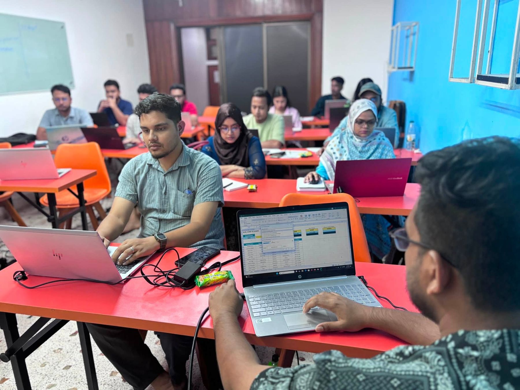 An instructor guiding a Data Solution 360 class from her laptop while learners follow along